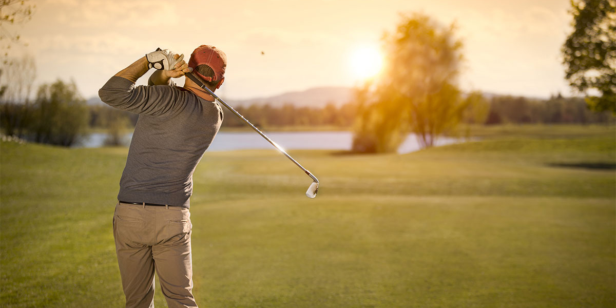 Golf player swinging golf club