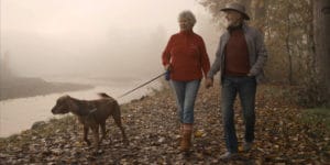 Roger and wife walking dog.