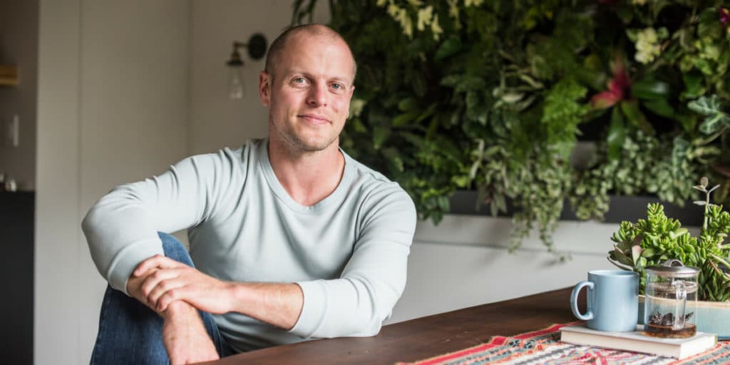 Photo of Tim Ferriss at desk.