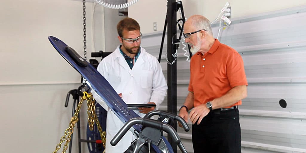 Roger Teeter looking at an inversion table.