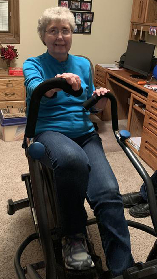 Teeter FreeStep Feel‑Good Exercise Club - Person exercising on FreeStep in home office