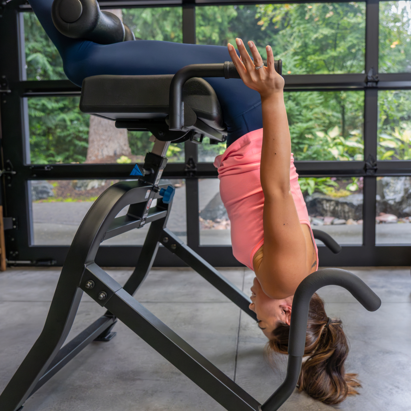 Person using DEX II in gym with traction handles