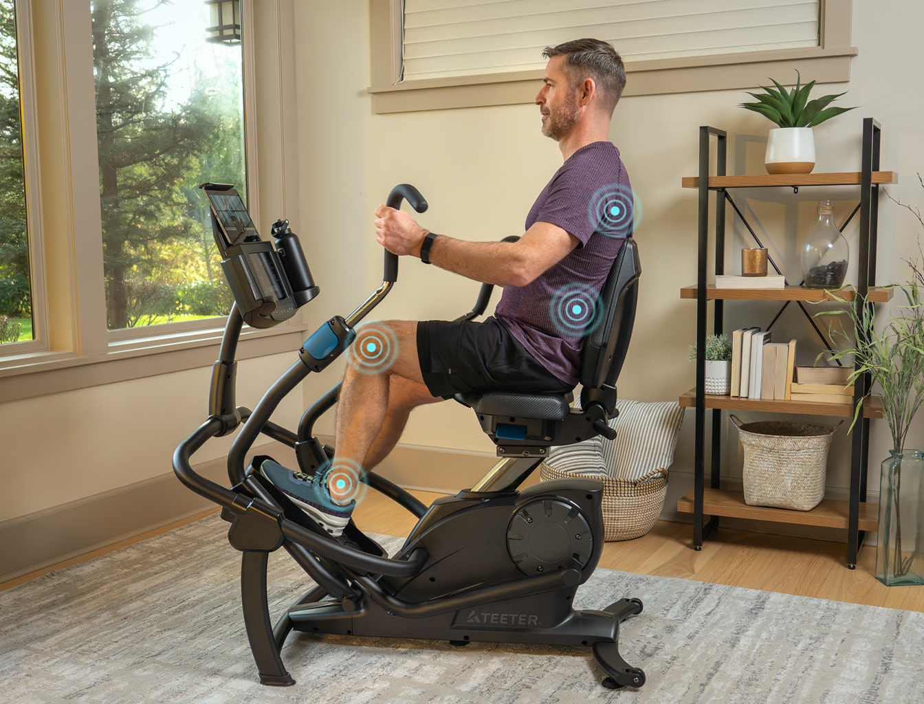 A man using Teeter FreeStep equipment in a bright, modern room.